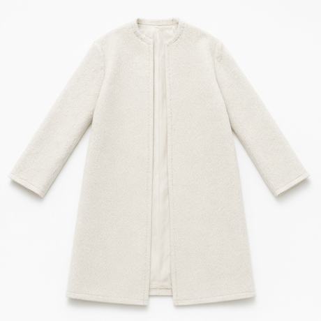 A bone-white wool coat, photographed flat